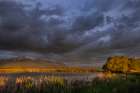 Wetlands pond reflects the Mission Mountains at sunset at Ninepipe NWR near Ronan, Montana, USA. Art Print